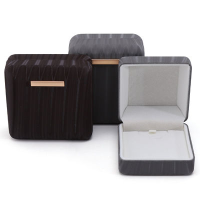 Caja de embalaje de joyas de cuero falso de granos de alta gama con ornamento de barra de oro